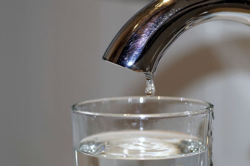 A tap with a glass of water