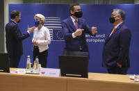 French President Emmanuel Macron, left, speaks with European Commission President Ursula von der Leyen as Hungary's Prime Minister Viktor Orban, right, speaks with Poland's Prime Minister Mateusz Morawiecki during a round table meeting at an EU summit in Brussels, Thursday, Dec. 10, 2020. European Union leaders meet for a year-end summit that will address anything from climate, sanctions against Turkey to budget and virus recovery plans. Brexit will be discussed on the sidelines. (AP Photo/Olivier Matthys, Pool)