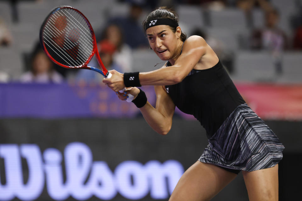 Caroline Garcia, of France, returns a shot from Maria Sakkari, of Greece, in the singles semifinals of the WTA Finals tennis tournament in Fort Worth, Texas, Sunday, Nov. 6, 2022. Garcia won the match in two sets. (AP Photo/Ron Jenkins)