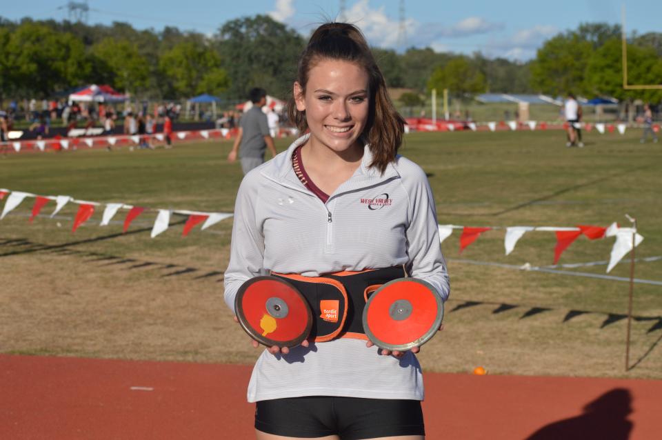 West Valley thrower Shelbie Rogers holds two discuses in her hands during the West Valley Invitational on Friday, April 22, 2022.