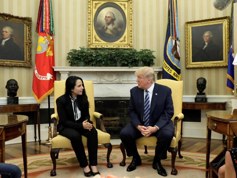 Aya Hijazi, an Egyptian-American woman detained in Egypt for nearly three years on human trafficking charges, meets with U.S. President Donald Trump in the Oval Office of the White House in Washington, U.S., April 21, 2017. REUTERS/Kevin Lamarque