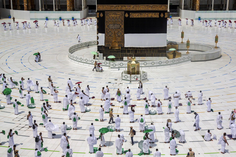 In this photo released by the Saudi Media Ministry, a limited numbers of pilgrims move several feet apart, circling the cube-shaped Kaaba in the first rituals of the hajj, as they keep social distancing to limit exposure and the potential transmission of the coronavirus, at the Grand Mosque in the Muslim holy city of Mecca, Saudi Arabia, Wednesday, July 29, 2020. The hajj, which started on Wednesday, is intended to bring about greater humility and unity among Muslims. (Saudi Media Ministry via AP)