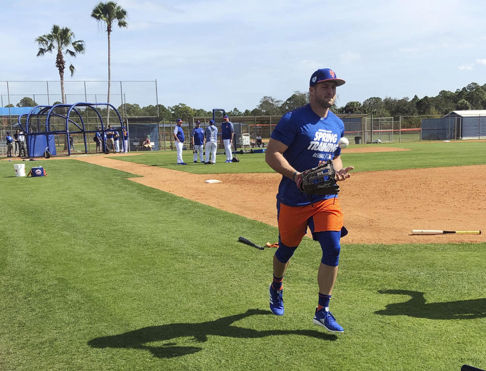 New York Mets' Tim Tebow jogs up the first baseline at spring training baseball practice Saturday, Feb. 16, 2019, in Port St. Lucie, Fla. (AP Photo/Mike Fitzpatrick)