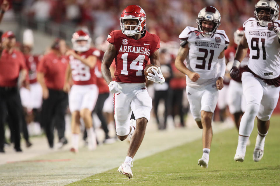 Sep 17, 2022; Fayetteville, Arkansas, USA; Arkansas Razorbacks punt returner Bryce Stephens (14) returns a punt for a touchdown against Missouri State Bears punter Grant Burkett (31) and defensive lineman JaÕVeo <a class="link " href="https://sports.yahoo.com/wnba/players/4563" data-i13n="sec:content-canvas;subsec:anchor_text;elm:context_link" data-ylk="slk:Toliver;sec:content-canvas;subsec:anchor_text;elm:context_link;itc:0">Toliver</a> (91) in the fourth quarter at Donald W. Reynolds Razorback Stadium. Arkansas won 38-27. Mandatory Credit: Nelson Chenault-USA TODAY Sports