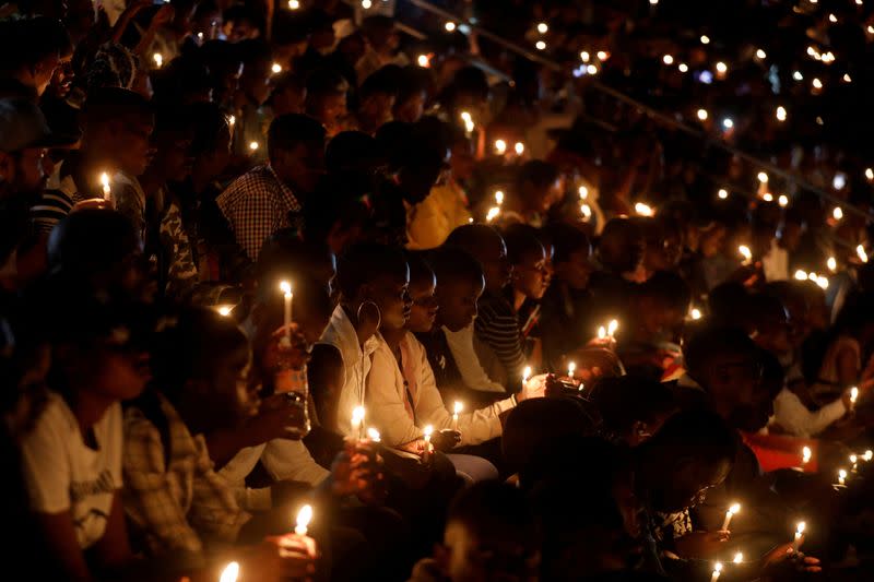 FILE PHOTO: Participants hold candles while holding a night vigil during a commemoration ceremony marking the 25th anniversary of the Rwandan genocide, at the Amahoro stadium in Kigali