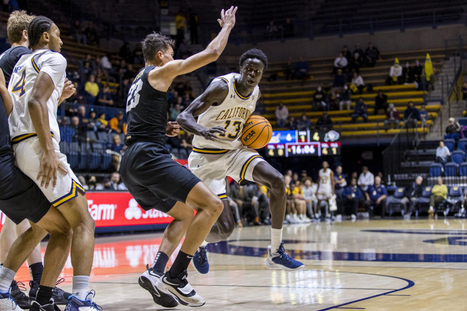 California forward Kuany Kuany (13) drives past Colorado forward Tristan da Silva (23) during the first half of an NCAA college basketball game in Berkeley, Calif., Saturday, Dec. 31, 2022. (AP Photo/John Hefti)