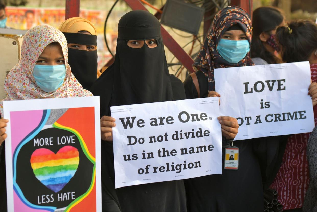 <span class="caption">Activist protest against 'love jihad' laws being proposed in India.</span> <span class="attribution"><a class="link " href="https://www.gettyimages.com/detail/news-photo/activists-belonging-to-various-human-and-civil-rights-news-photo/1229888083?adppopup=true" rel="nofollow noopener" target="_blank" data-ylk="slk:Manjunath Kiran/AFP via Getty Images;elm:context_link;itc:0;sec:content-canvas">Manjunath Kiran/AFP via Getty Images</a></span>