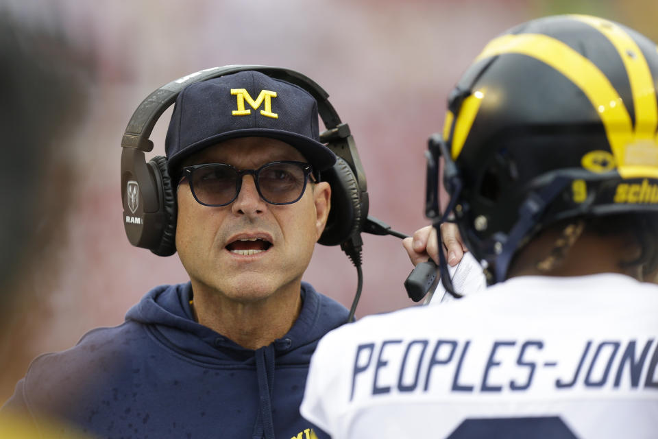 Michigan head coach Jim Harbaugh talks with wide receiver Donovan Peoples-Jones during the first half of an NCAA college football game against Wisconsin Saturday, Sept. 21, 2019, in Madison, Wis. Wisconsin won 34-14. (AP Photo/Andy Manis)