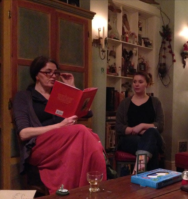 Kris Burns reads "A Christmas Memory" in 2013. Her daughter, Sadie, listens.