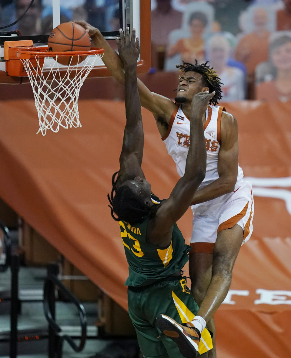 Texas forward Greg Brown, right, scores over Baylor forward Jonathan Tchamwa Tchatchoua (23) during the second half of an NCAA college basketball game Tuesday, Feb. 2, 2021, in Austin, Texas. (AP Photo/Eric Gay)
