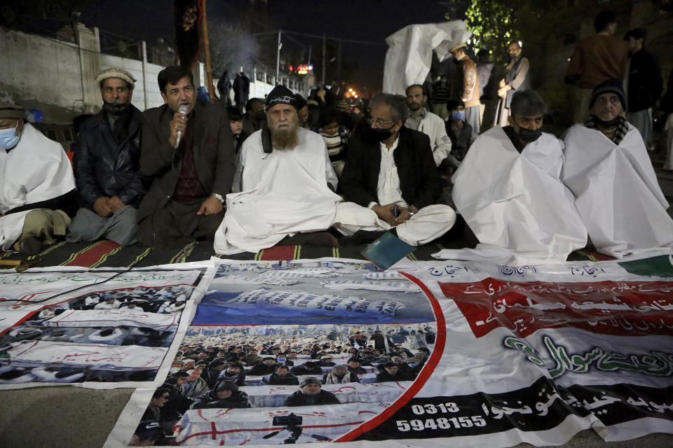 Shiite Muslims participate in a sit-in to protest against the killing of coal mine workers by gunmen near the Machh coal field, in Peshawar, Pakistan, Friday, Jan. 8, 2021. Pakistan's prime minister Friday appealed the protesting minority Shiites not to link the burial of 11 coal miners from Hazara community who were killed by the Islamic State group to his visit to the mourners, saying such a demand amounted to blackmailing the country's premier. (AP Photo/Muhammad Sajjad)