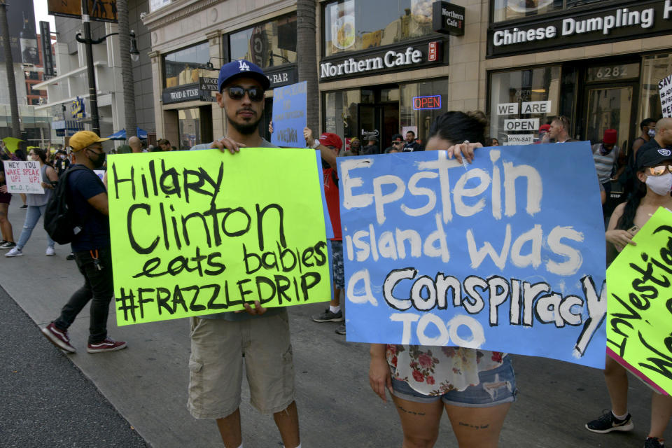 People hold signs at a "Save our children" protest