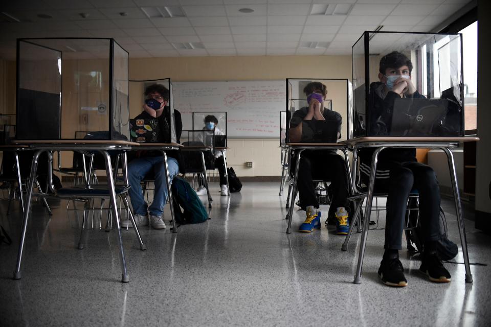In this March 18, 2021, file photo, students listen to a presentation in Health class at Windsor Locks High School in Windsor Locks, Conn.