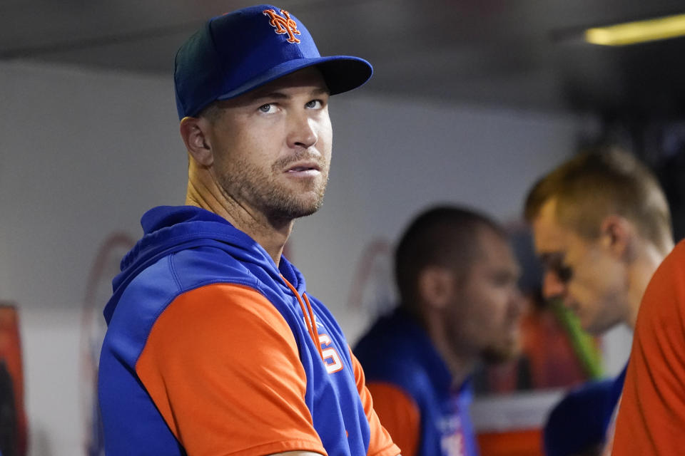 Injured New York Mets pitcher Jason deGrom watches from the dugout during the seventh inning of the team's baseball game against the Washington Nationals, Tuesday, May 31, 2022, in New York. (AP Photo/Mary Altaffer)