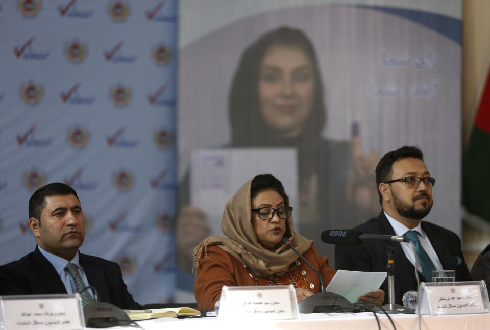 Hawa Alam Nuristani, chief of Election Commission of Afghanistan, center, speaks during a press conference at the Independent Election Commission office in Kabul, Afghanistan, Sunday, Dec. 22, 2019. The election commission is to announce the results of the Sept. 28 election Sunday. (AP Photo/Rahmat Gul)