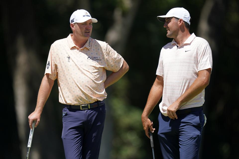 Jason Kokrak, left, and Scottie Scheffler, right, talk as they play through the eighth hole during the second round of the Charles Schwab Challenge golf tournament at the Colonial Country Club, Friday, May 27, 2022, in Fort Worth, Texas. (AP Photo/LM Otero)