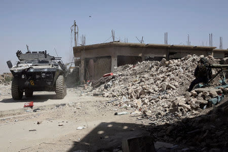 An armoured vehicle of the Iraqi Federal Police fires against positions of Islamic State fighters in western Mosul, Iraq May 29, 2017. REUTERS/Alkis Konstantinidis