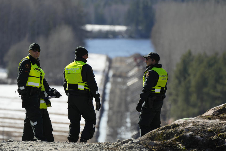 Finland's border guards stay at construction site of the border barrier fence between Finland and Russia near Pelkola border crossing point in Imatra, south-eastern Finland, Friday, April 14, 2023. (AP Photo/Sergei Grits)