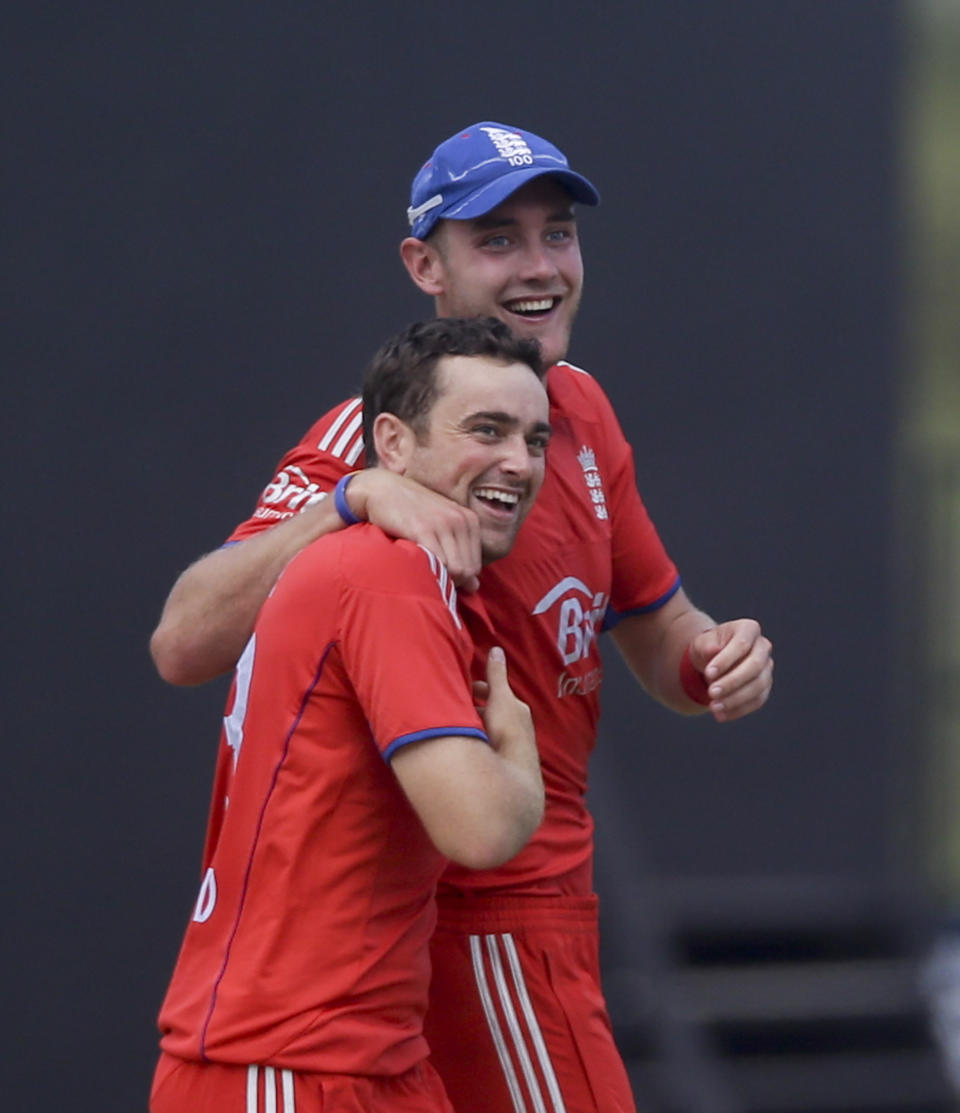 England's captain Stuart Broad, back, and Stephen Parry celebrate after taking the wicket off West Indies' Darren Sammy during their second one-day international cricket match at the Sir Vivian Richards Cricket Ground in St. John's, Antigua, Sunday, March 2, 2014. (AP Photo/Ricardo Mazalan)