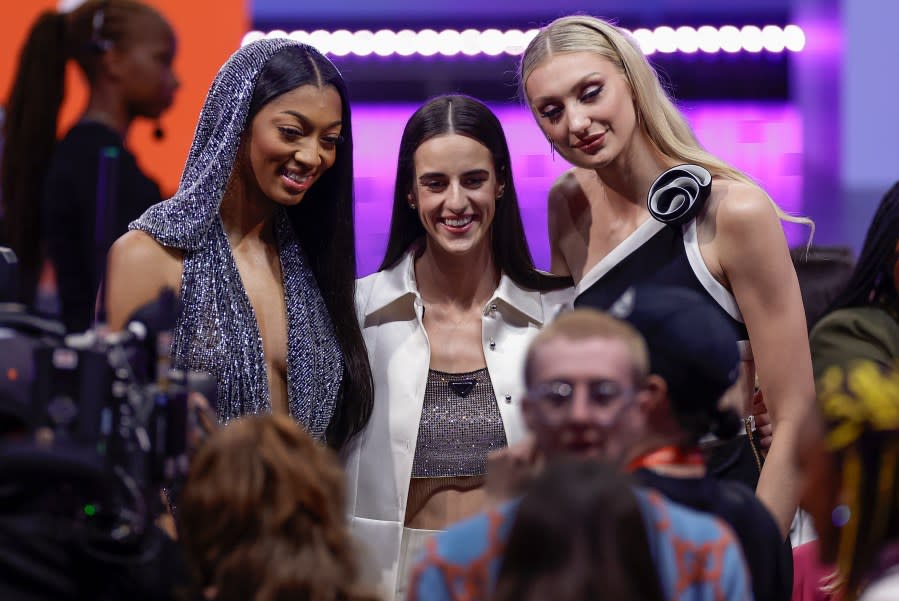 From left, LSU’s Angel Reese, Iowa’s Caitlyn Clark, and Stanford’s Cameron Brink, pose for a photo before the start of the WNBA basketball draft, Monday, April 15, 2024, in New York. (AP Photo/Adam Hunger)