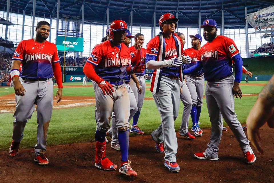 Mar 13, 2023; Miami, Florida, USA; Dominican Republic third baseman Manny Machado (center) celebrates with teammates after hitting a home run during the seventh inning against Nicaragua at LoanDepot Park. Mandatory Credit: Sam Navarro-USA TODAY Sports