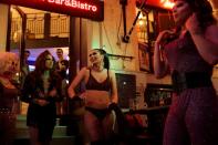 Transgender woman Daniella Milla Tokodi smiles during a drag queen show at a bar in Budapest