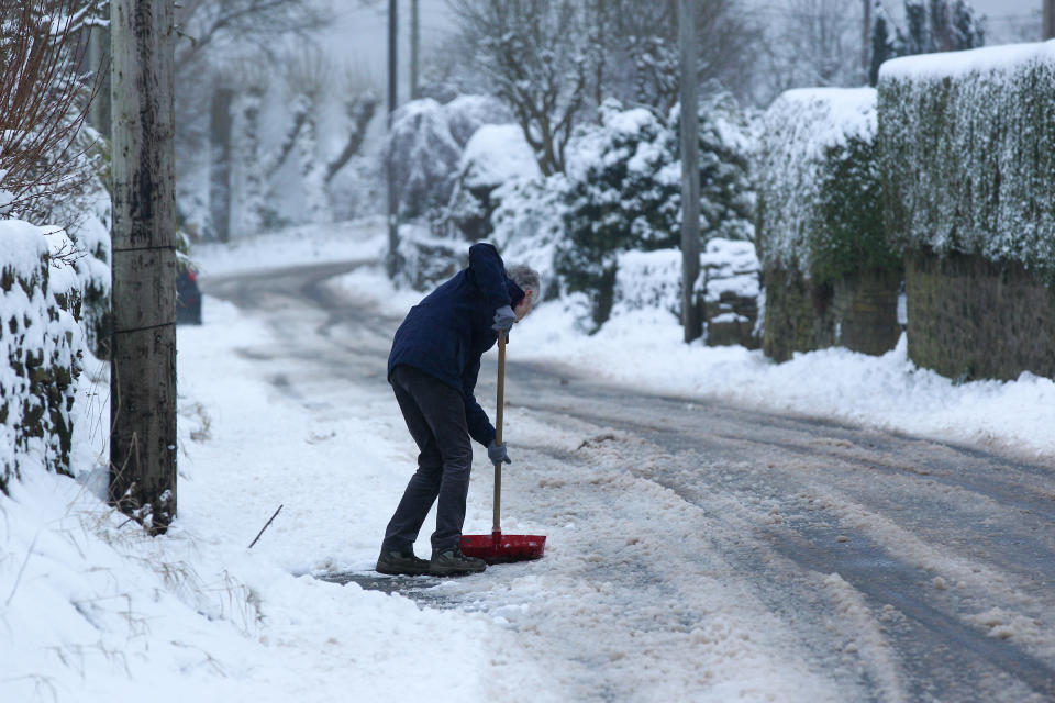 A woman shovels snow on a lane in West Yorkshire. Heavy snow fell overnight in West Yorkshire, causing dangerous driving conditions. (Photo by Adam Vaughan / SOPA Images/Sipa USA)