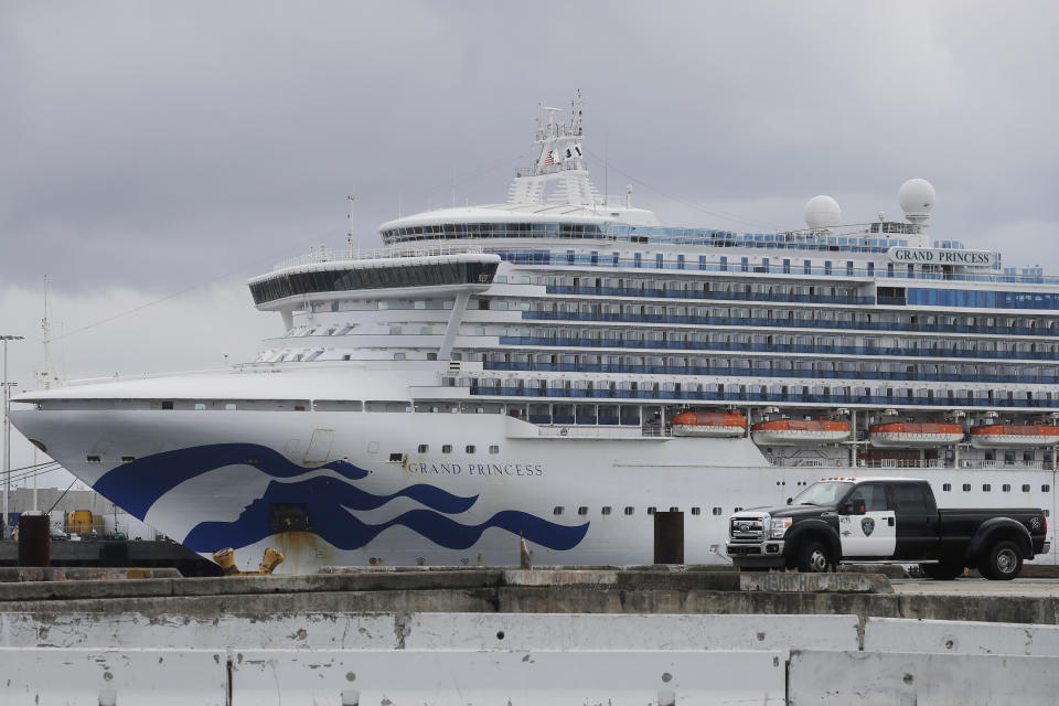 FILE - In this March 15, 2020, file photo, the Grand Princess cruise ship is shown docked at the Port of Oakland in Oakland, Calif. Nearly 650 crew members of the Grand Princess have completed their 14-day quarantine, ending a month-long period of self-isolation that began when the cruise ship was struck with the coronavirus. The cruise line said the crew members can finally leave their staterooms Saturday, April 4, and roam around the ship as long as they wear personal protective equipment and stay at least six feet from each other. The ship will leave San Francisco Bay and sail out to sea for several days of routine marine operations. Two passengers and a crew member on board the ship have died from COVID-19, while at least 103 have tested positive for the coronavirus. (AP Photo/Jeff Chiu, File)