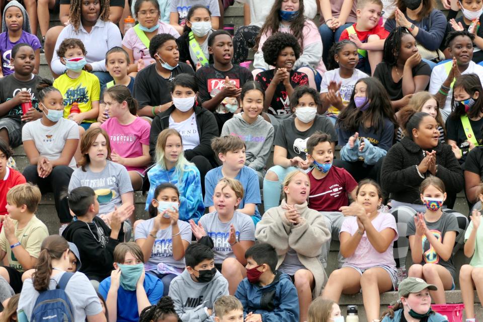 Students sit in the stands at Citizens Field in east Gainesville during Fifth Grade Field Day on March 31, 2022.