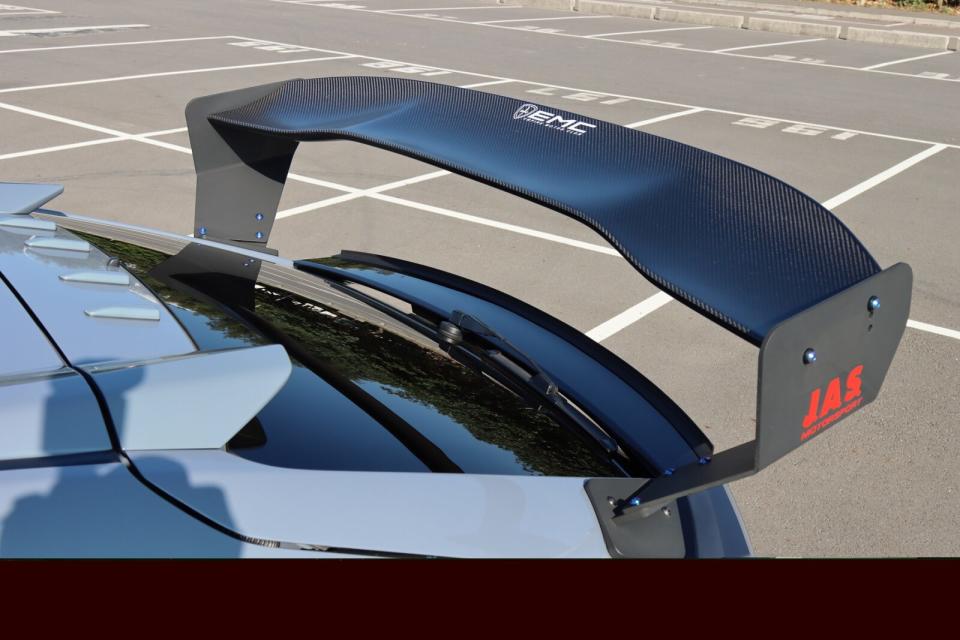 這組尾翼為RMK Design推出的GT尾翼，兩側支撐架為鋁合金材質，造型上則盡可能往兩側外推，至於翼板本身採用碳纖維材質打造，且為3D曲面設計，除了外型好看外，更可提供強大的車尾下壓力。