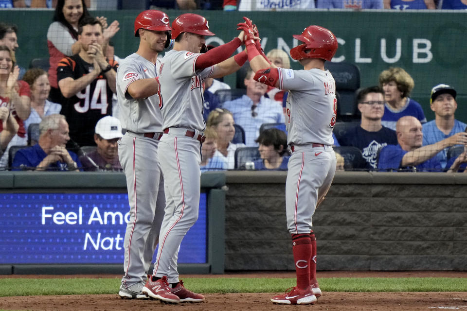Cincinnati Reds' Matt McLain, right, celebrates with teammates after hitting a three-run home run during the fifth inning of a baseball game against the Kansas City Royals Wednesday, June 14, 2023, in Kansas City, Mo. (AP Photo/Charlie Riedel)