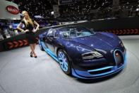 A Bugatti Veyron Grand Sport Vitesse is displayed at the car maker's booth ahead of the Geneva Motor Show. Sports cars, reputed for being energy guzzlers, are now trying to boost their green credentials as they seek to attract environmentally conscious consumers and meet new climate standards