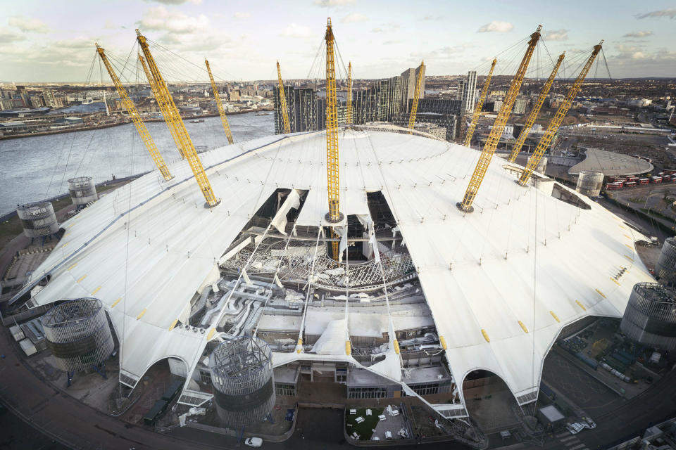 A view of damage to the roof of the O2 Arena, caused by Storm Eunice, in south east London, Friday, Feb. 18, 2022. London Fire Brigade said that there were no reports of any injuries as around 1,000 people were evacuated from the building, formerly known as the Millennium Dome, which hosts major events including concerts and features restaurants, bars, shops and a cinema. Millions of Britons were urged to cancel travel plans and stay indoors Friday amid fears of high winds and flying debris as the second major storm in the week prompted a rare "red" weather warning across southern England. (Stefan Rousseau/PA via AP)