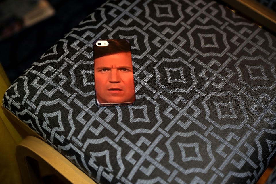 <p>An iPhone case with Tucker Carlson’s face is left in a chair during the Conservative Political Action Conference at the Gaylord National Resort and Convention Center, Feb. 23, 2018 in National Harbor, Md. (Photo: Chip Somodevilla/Getty Images) </p>
