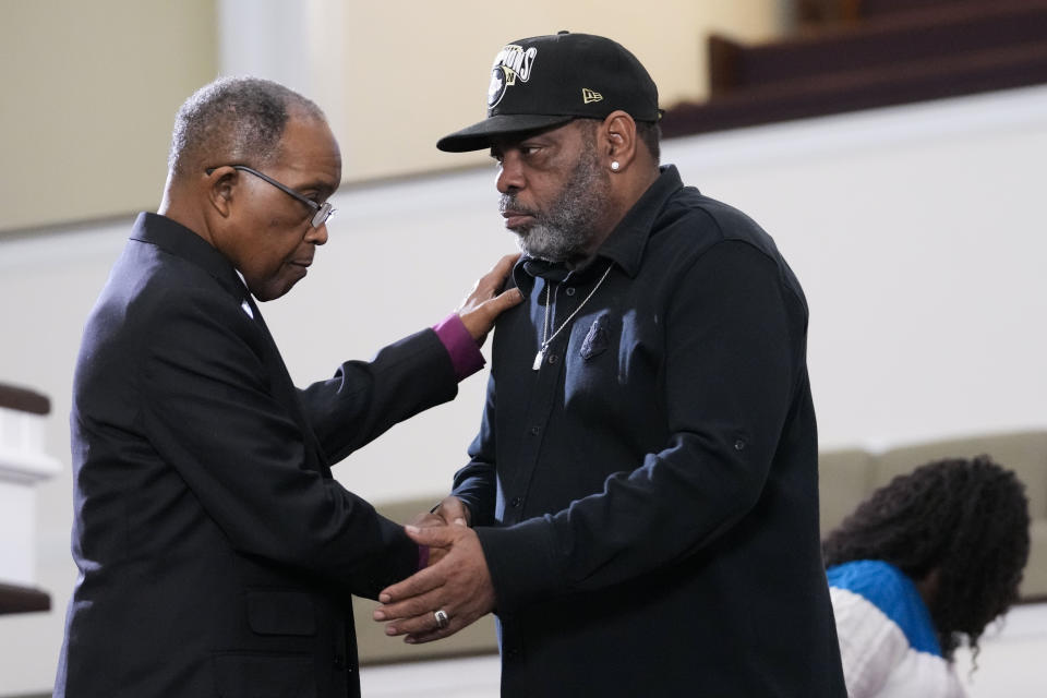 Rodney wells, right, stepfather of Tyre Nichols, who died after being beaten by Memphis police officers, is comforted by Bishop Henry Williamson after a news conference in Memphis, Tenn., Monday, Jan. 23, 2023. (AP Photo/Gerald Herbert)