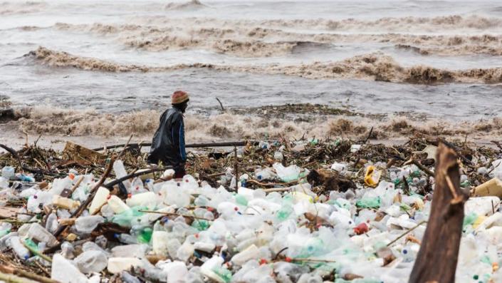 Man near debris at Blue Lagoon beach