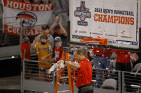 Houston head coach Kelvin Sampson celebrates with the team following Houston's win over Cincinnati an NCAA college basketball game in the final round of the American Athletic Conference men's tournament Sunday, March 14, 2021, in Fort Worth, Texas. (AP Photo/Ron Jenkins)