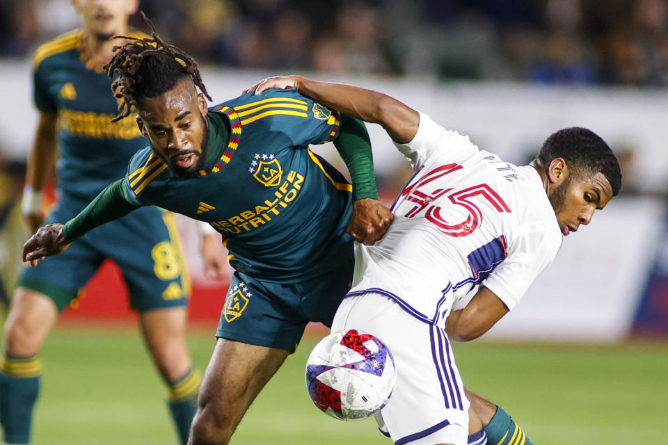 LA Galaxy forward Raheem Edwards, left, and Vancouver Whitecaps midfielder Pedro Vite vie for the ball during the second half of an MLS soccer match in Carson, Calif., Saturday, March 18, 2023. (AP Photo/Ringo H.W. Chiu)