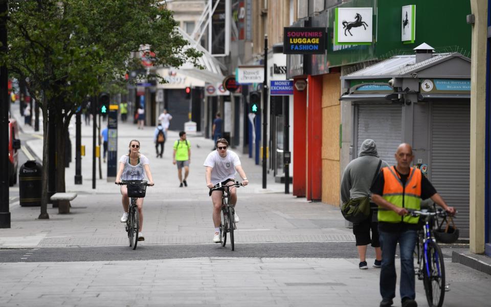 Mandatory Credit: Photo by NEIL HALL/EPA-EFE/Shutterstock (10659777bb) People pass shut stores on Oxford Street in London, Britain, 27 May 2020. Non-essential shops have been given the go-ahead to open their doors again on 15 June. Coronavirus in Britain, London, United Kingdom - 27 May 2020 - Shutterstock