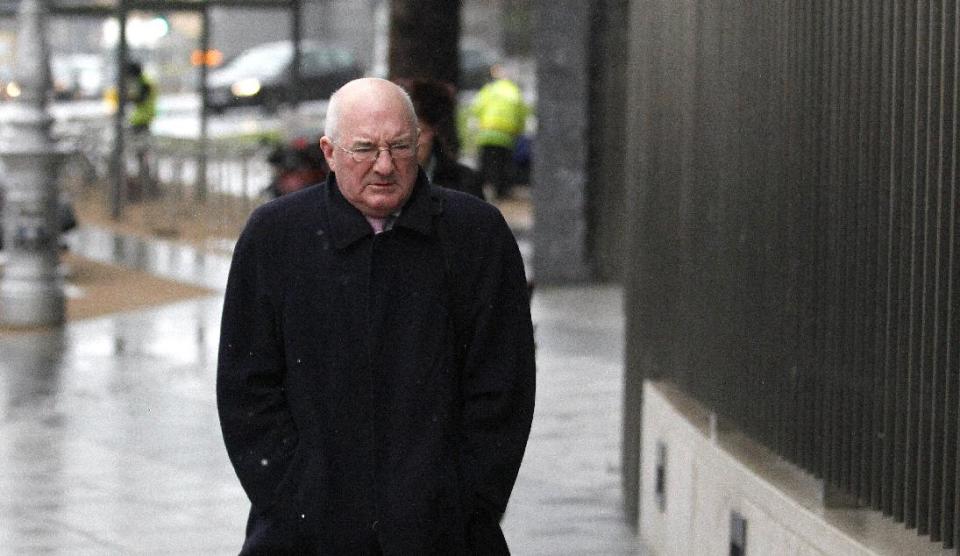 FILE - In this Wednesday, Feb. 5, 2014, file photo former finance director of Anglo Irish Bank Willie McAteer arrives at Dublin Criminal Court, Ireland. McAteer is charged along with two other former Anglo Irish Bank members with trying to inflate the share price. The judge overseeing the 10-week-old trial issued surprise acquittal instructions to jurors Wednesday, April 9, 2014, after prosecutors finished their case against Sean FitzPatrick, Pat Whelan and Willie McAteer. Their defense starts this week. The judge dropped six charges against Anglo’s former chairman FitzPatrick and seven charges against former lending director Whelan. The three men still face 42 charges of secretly lending more than 500 million euros ($700 million) to top clients for them to buy Anglo’s sagging shares in 2008. (AP Photo/Peter Morrison, File)