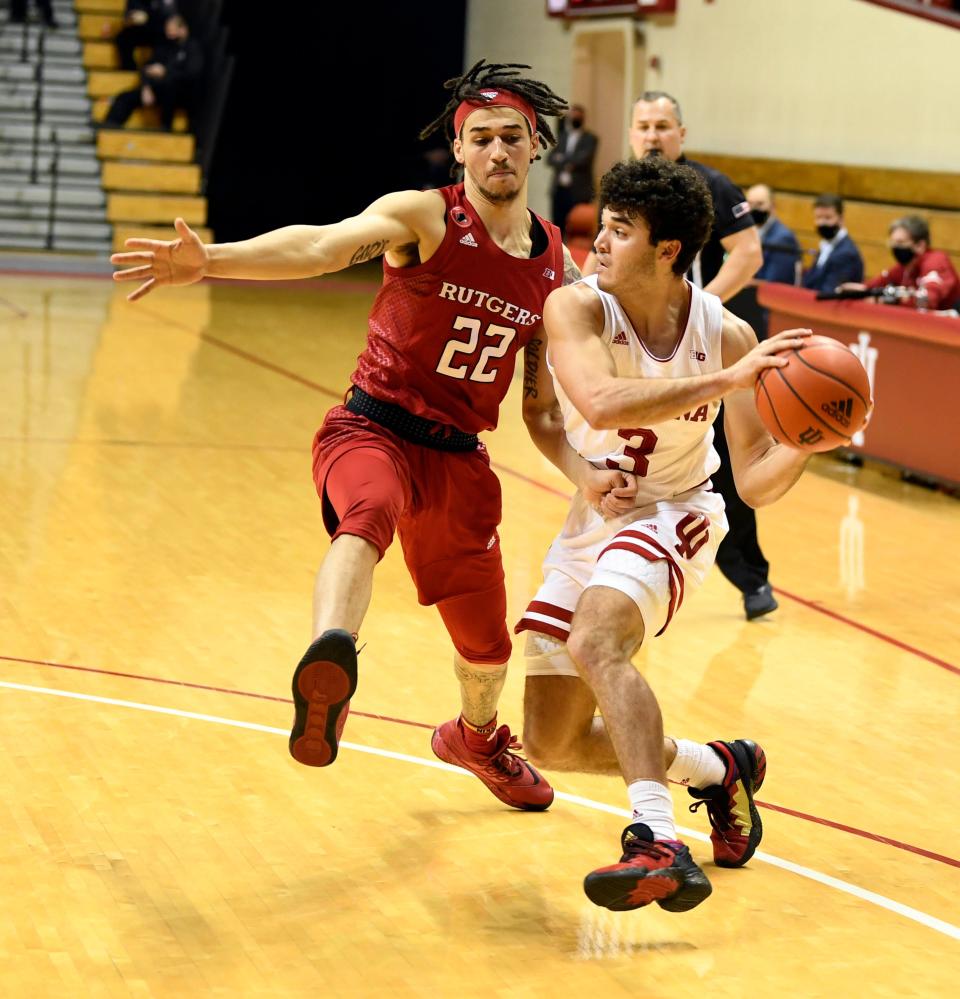 Indiana Hoosiers guard Anthony Leal (3) passes the ball away from Rutgers Scarlet Knights guard Caleb McConnell (22) during the first half of the game at Simon Skjodt Assembly Hall.