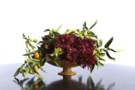 <p>A centerpiece that incorporates both regional fruits and Christmas colors is a lovely option for those celebrating the holiday in warm climates. This arrangement focuses on one type of flower, but accents it with unexpected citrus branches. </p><p><em>Via <a href="http://www.decorationinc.com" rel="nofollow noopener" target="_blank" data-ylk="slk:Decoration Inc.;elm:context_link;itc:0;sec:content-canvas" class="link ">Decoration Inc.</a> </em></p>