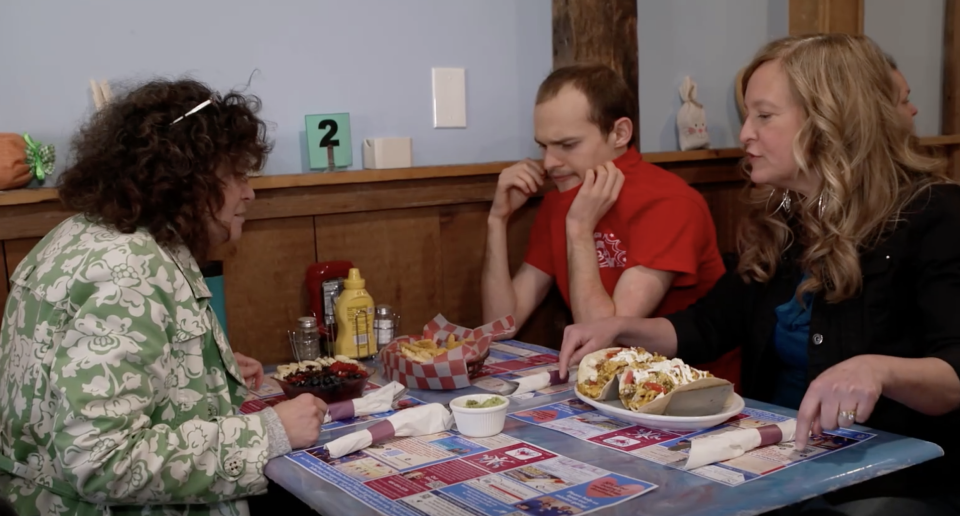 Maureen Stanko, her son Nick and his aide at the So Much To Give cafe. / Credit: CBS News