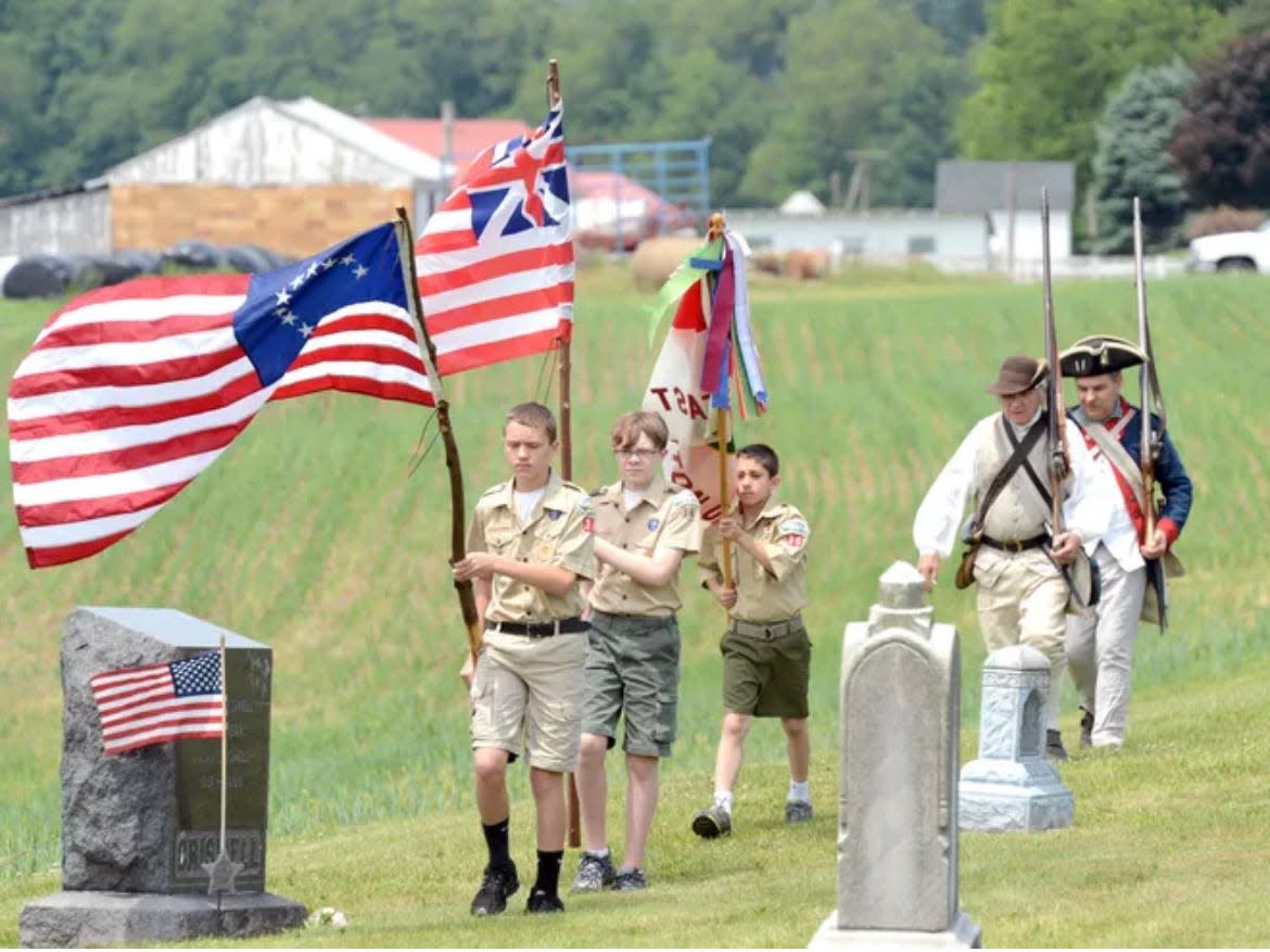 In this file photo from 2013, Boy Scout Troop 36 members Evan Mayle, John Golden and Mikey Milton, along with American Revolutionary War reenactors Ron Pfouts and John McDowell, present the colors at the grave site of Pvt. Jacob Shearer, a Revolutionary War soldier.