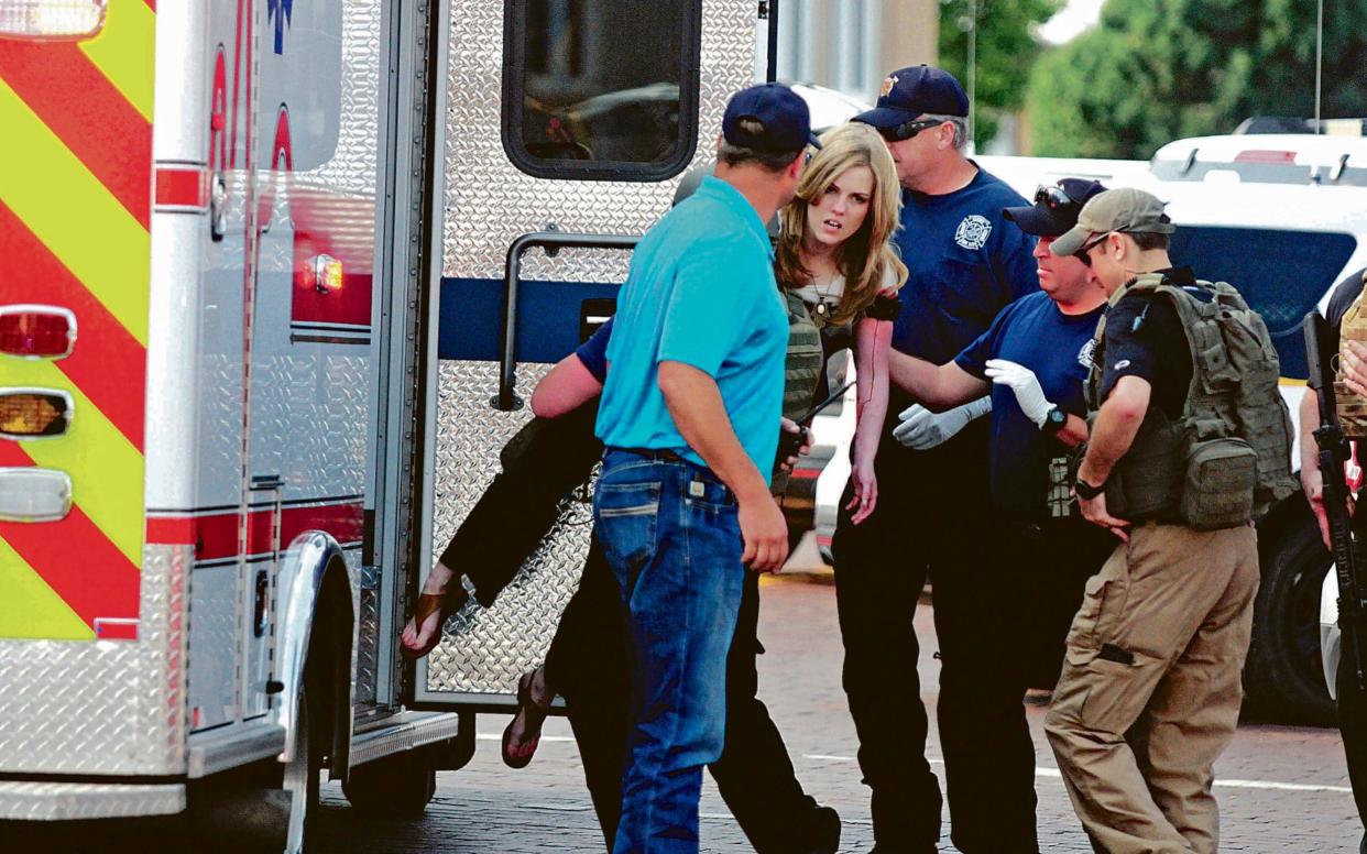 An injured woman is carried to an ambulance in Clovis - The Eastern New Mexico News