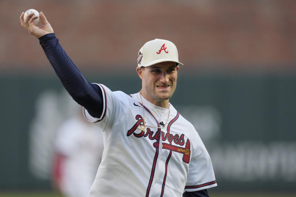 Atlanta Falcons quarterback Kirk Cousins throws out the ceremonial first pitch before a baseball game between the Texas Rangers and the Atlanta Braves Sunday, April 21, 2024, in Atlanta. (AP Photo/John Bazemore)