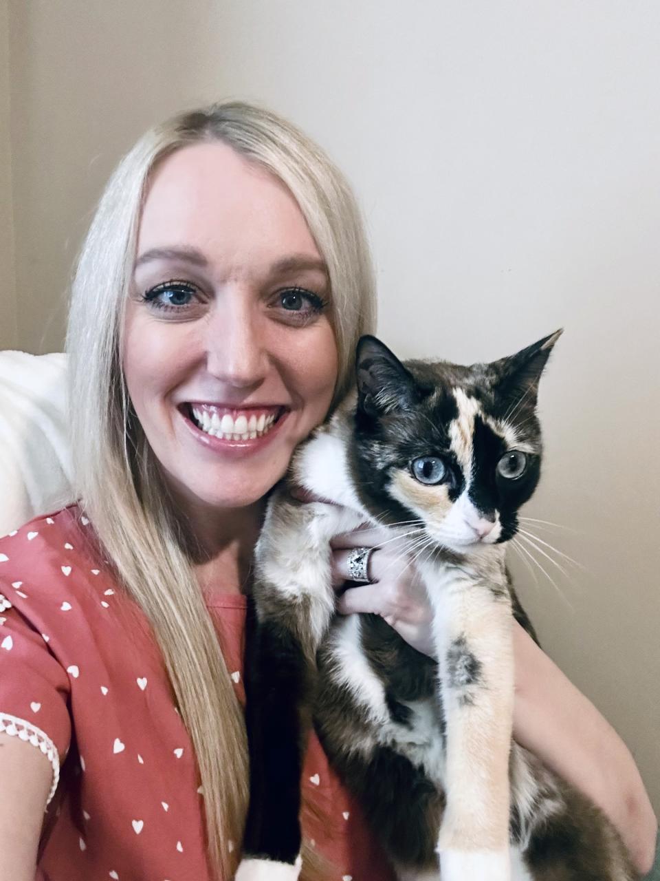 In this photo provided by Carrie Clark of Lehi, Utah, Carrie poses with Galena, a 6-year-old house cat. Clark says Galena went missing after jumping into a box being returned to Amazon without its owners noticing. (Carrie Clark via AP Photo)