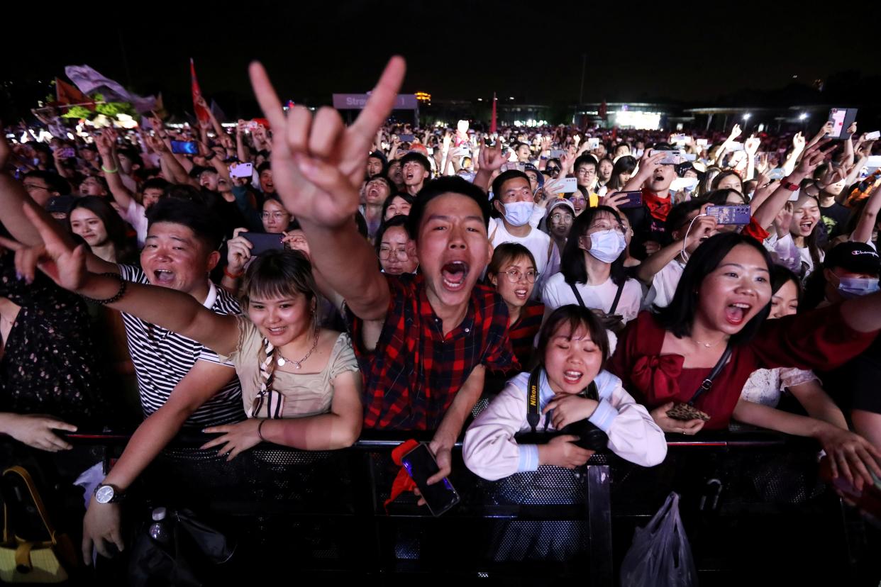 <p>Fans attend a performance of a rock band at the Strawberry Music Festival during Labour Day holiday in Wuhan, China</p> (Reuters)