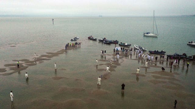 Members of the Royal Southern Yacht Club and the Island Sailing Club during the annual Brambles cricket match between the clubs, which takes place on the Bramble Bank sandbank in the middle of the Solent at low tide (Steve Parsons/PA)