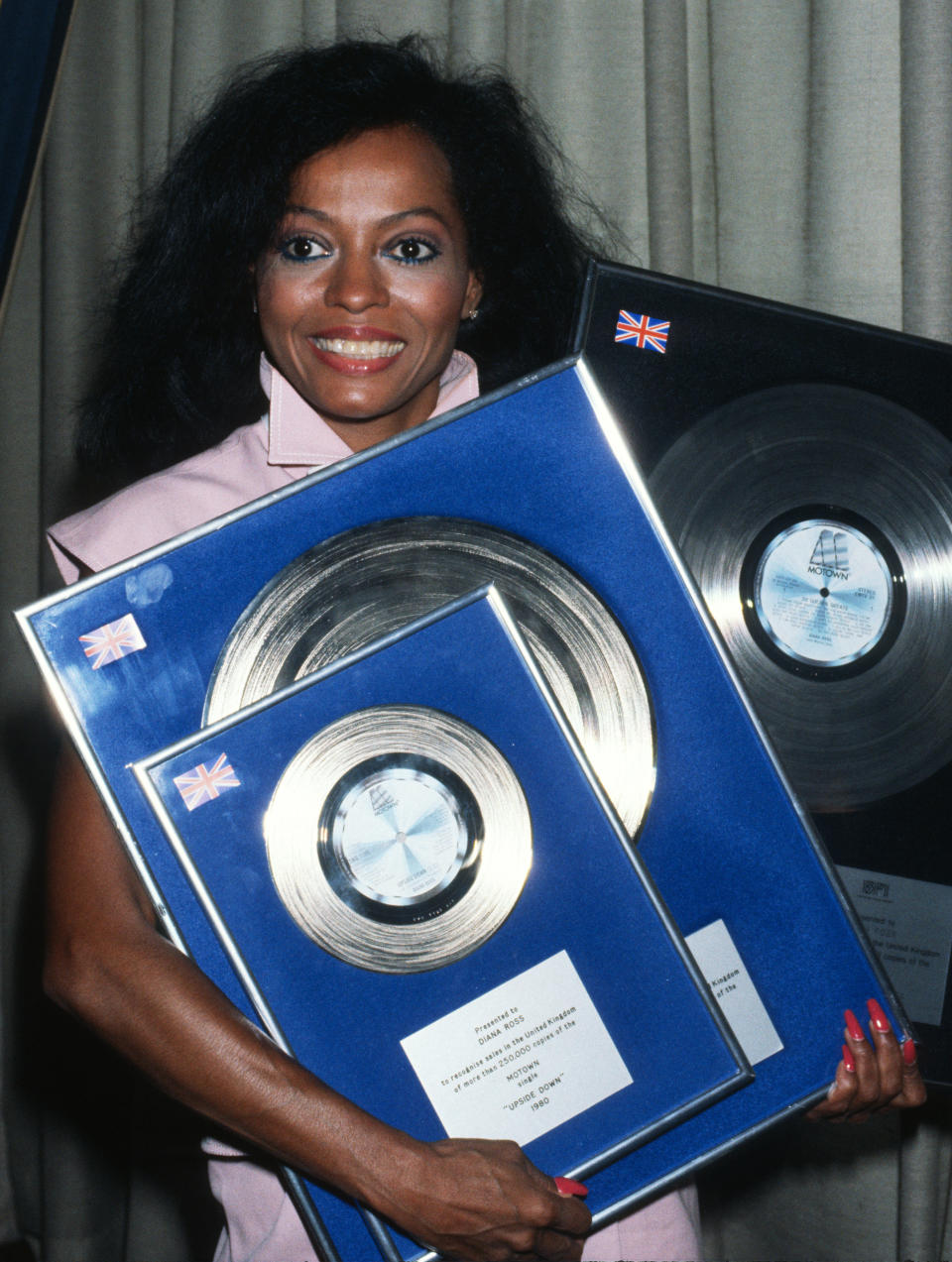 Diana Ross receives an award for the sale of her Motown single 'Upside Down' during a visit to England in 1980 in London,  England. (Photo by Anwar Hussein/Getty Images)